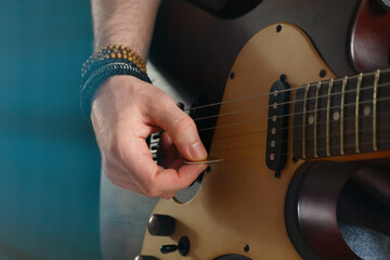 Man playing electric guitar on stage, closeup. Rock concert