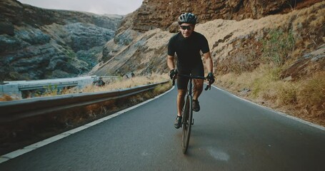 Road biker cycling on epic country road, intense workout and fitness, healthy active lifestyle - Powered by Adobe