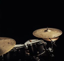 Parts of a drumset in dark environment with empty space