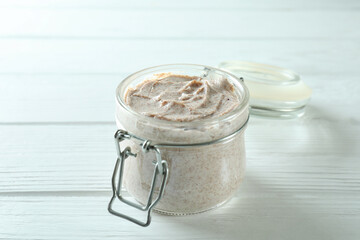 Skin care scrub on white wooden background