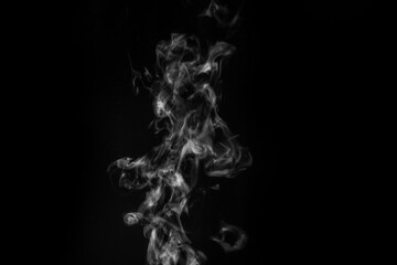 White smoke on black background. Figured smoke on a dark background. Abstract background, design element