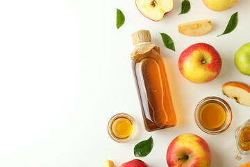 Homemade apple vinegar and ingredients on white background