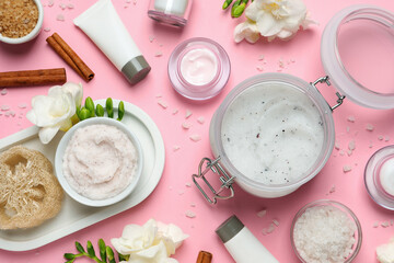 Flat lay composition with body scrubs on pink background