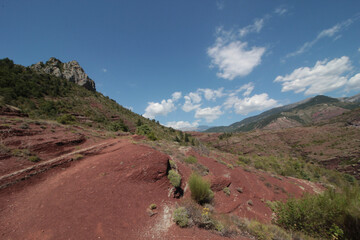Fototapeta premium Daluis gorges regional natural reserve. Remarkable gorges carved out by the Var in red wine-red rocks. Lutite rocks, sedimentary rocks, which are composed of silt-size sediment, clay-size sediment. 
