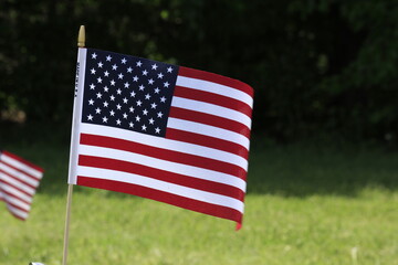 US Flags flying on Memorial Day in a Cemetery in Hutchinson Kansas USA that's bright and colorful on this Holiday.
