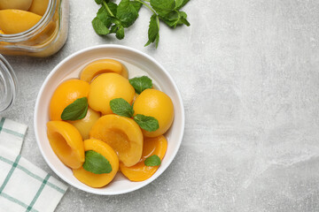 Canned peach halves on light table, flat lay. Space or text
