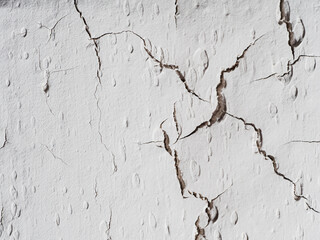 many cracks on the light wall. Textured background