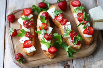 Beautiful bruschetta with strawberries and cheese. Strawberry toast. Healthy summer food.