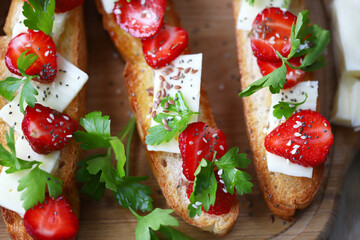 Beautiful bruschetta with strawberries and cheese. Strawberry toast. Healthy summer food.
