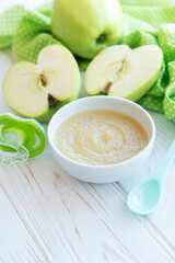 Bowl with fruit baby food and apples