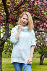 Woman on nature walk at spring park. Portrait photo of happy Caucasian woman in common clothes relaxing in outdoors park and have a good time on weekend activity