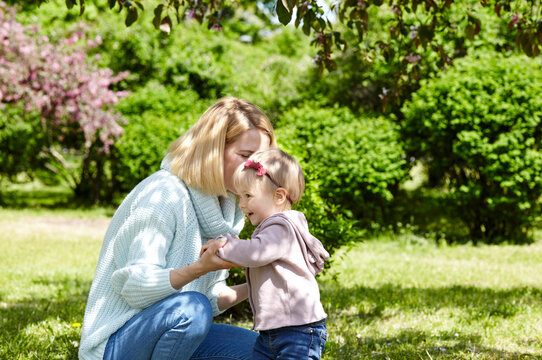 Mom and daughter on nature walk at spring park. Little girl and mother have a good time on weekend activity