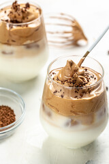 Dalgona coffee or whipped instant coffee. frothy coffee trend korean drink latte espresso with coffee foam, vertical image. top view