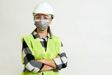 Worker woman wearing face mask and protective hard hat.