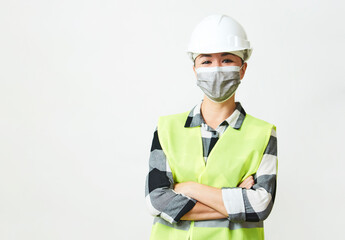 Worker woman wearing face mask and protective hard hat.