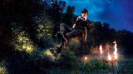 Peter Pen flies and plays the flute against the background of the forest with fairies. Cosplay on...