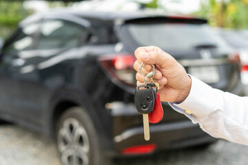 selling car, car sale, deal concept The dealer gives the car keys to the new owner or renter with...