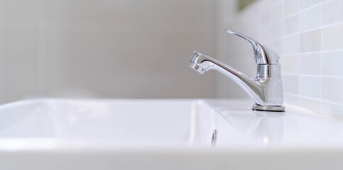 The bathroom faucet is turned off to save water energy and protect the environment. water saving...