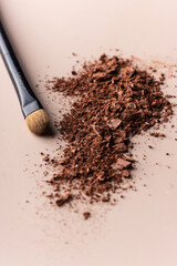 broken eye shadow scattered across the smooth pink surface. Texture background, advertising the structure of cosmetics. macro, copyspace