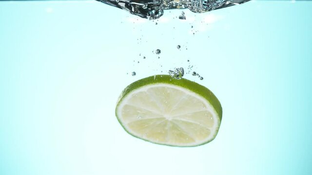 Super slow motion of falling lime slices into splashing water. Filmed on high speed cinema camera, 1000 fps.