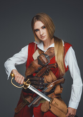 Medieval woman buccaneer with saber wearing red coat