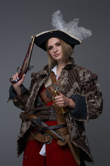 Medieval woman pirate with saber and handgun