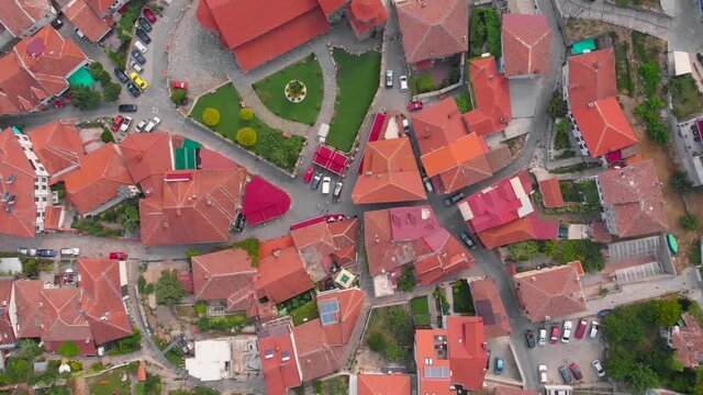 Orthodox church at old town of Ohrid, North Macedonia and village of houses with red roofs. Medieval old gothic architectures look beautiful from above sky with aerial drone 4K 30fps. 