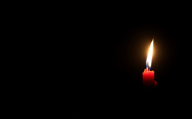 Light for life - Red candle with yeallow frame against black background