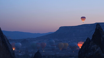 Hot air baloons preparing for take off. Famous sightseeing Cappadocia. Lights of air balloons.
