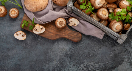 Champinion mushrooms on dark background. Vegan food concept.