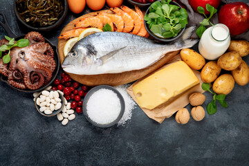 Food high in iodine on dark gray background. Healthy eating concept.