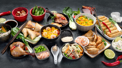 Assorted Chinese dishes and snacks on dark gray background. Traditional food concept.