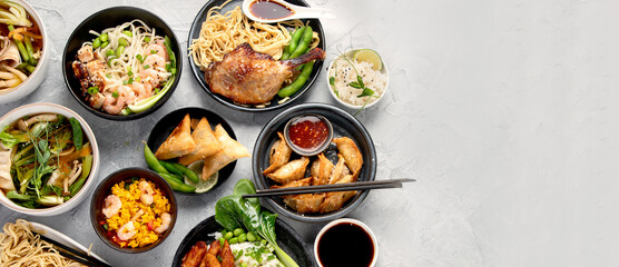 Assorted asian dishes and snacks on dark gray background. Traditional food concept.