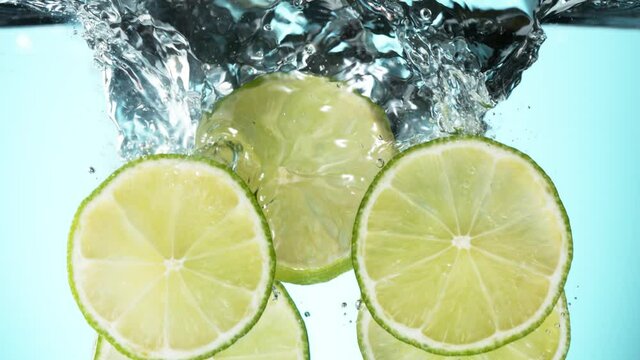 Super slow motion of falling lime slices into splashing water. Filmed on high speed cinema camera, 1000 fps.