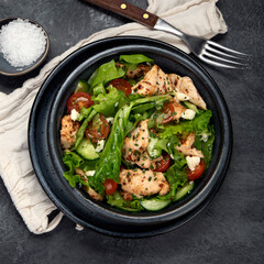 Fresh chicken salad on drak gray background. Healthy food concept.