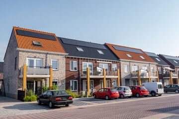 Newly build houses with solar panels attached on the roof against a sunny sky Close up of new...