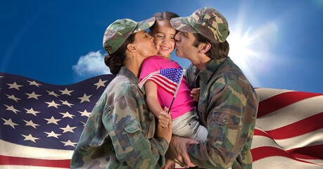Composition of male and female soldier parents kissing their daughter holding american flag