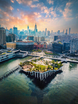 New York, United States - June 1, 2021:  Little Island park at Pier 55 in New York new landmark of the city with Manhattan skyscrapers rising above