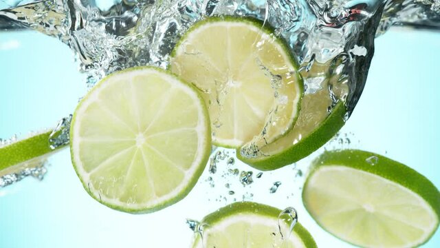 Super slow motion of falling lime slices into splashing water. Filmed on high speed cinema camera, 1000 fps.