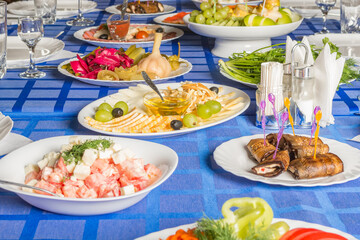 Dinner table with food and drinks set in honor of the feast.