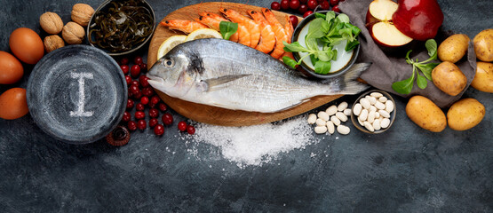 Food high in iodine on dark gray background. Healthy eating concept.