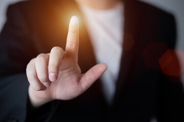 Businessman pushing a button on a touch screen interface , Finger pointing in the empty space. with business and advertising copy space.