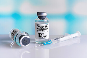 Covid-19 Vaccine Vials for vaccination of population tagged with 1st dose. Coronavirus vaccine bottle with the name of the First dose of vaccine on the label