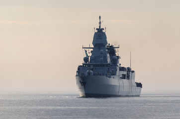 WARSHIP - Guided missile frigate flows to the port - obrazy, fototapety, plakaty