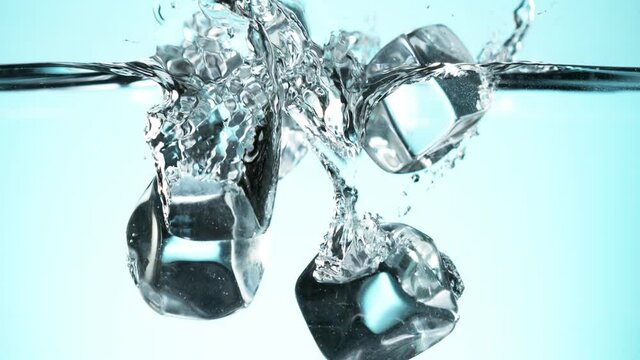 Super slow motion of falling ice cubes into water. Filmed on high speed cinema camera, 1000 fps.