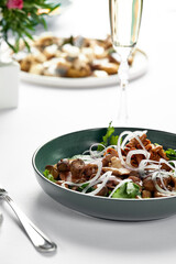Assorted salted mushrooms, on a plate on a festively decorated table with white tablecloths, a mix of lance mushrooms