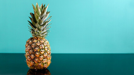 Fresh pineapple on green blue background