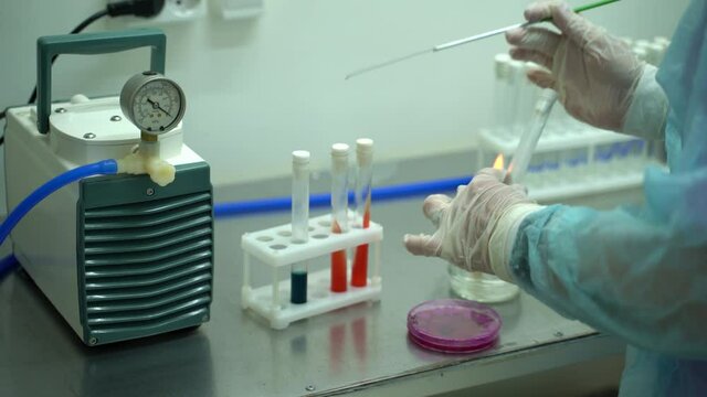 Young caucasian scientist takes samples for Covid 19 vaccination, Coronavirus vaccine for 2022-nCoV COVID virus. Female laborant holding medical tube with samples of vaccine. Preventive medications