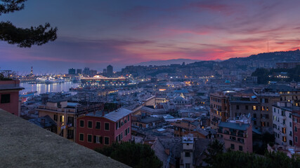 Fototapeta na wymiar View of the port of Genoa at sunset from Spianata Castelletto, Italy.