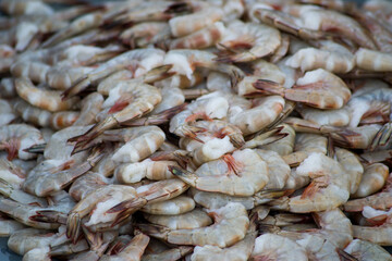 A bunch of headless shrimp are sold in the traditional fish market - obrazy, fototapety, plakaty